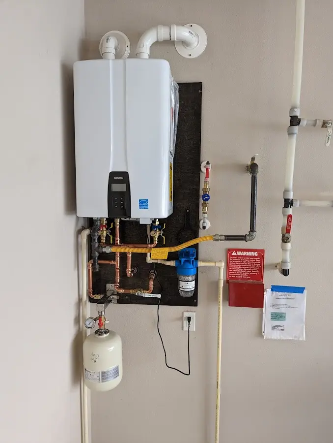 Professional plumber installing copper piping in a Holiday Shores home